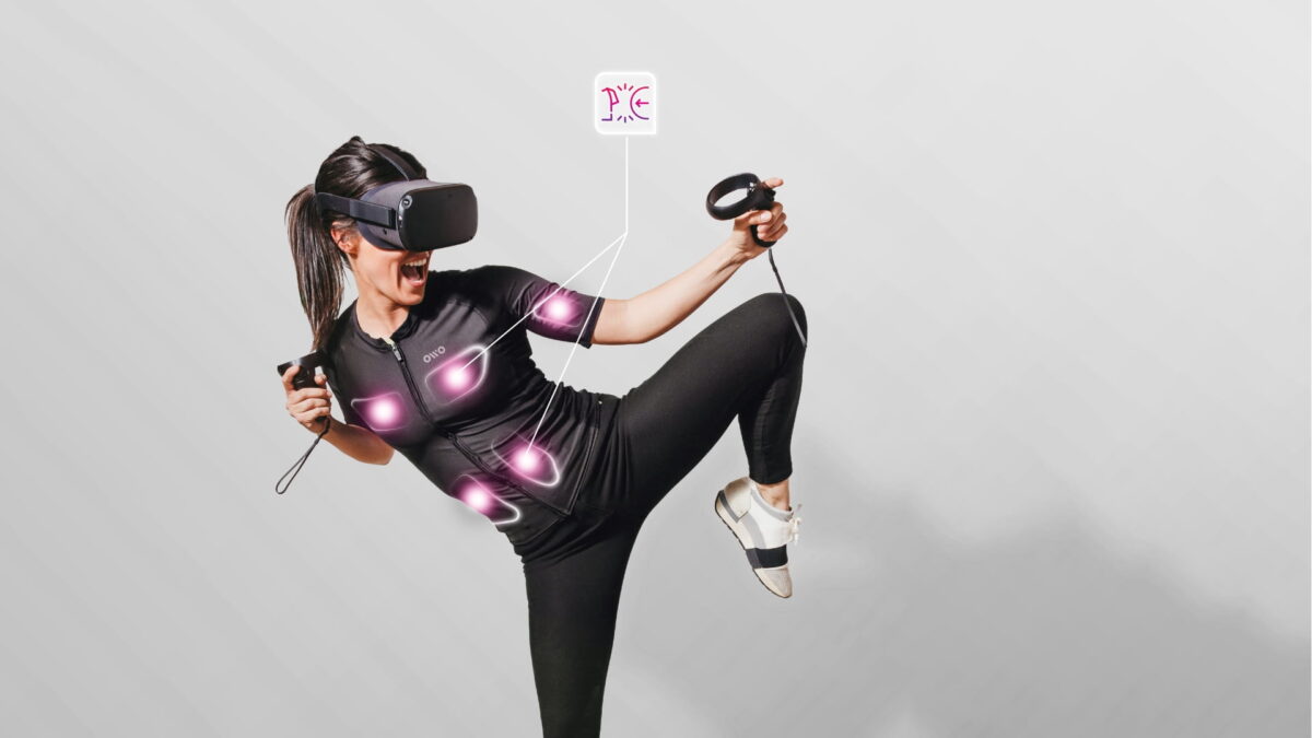 A woman wears OWO's haptic shirt and VR goggles.