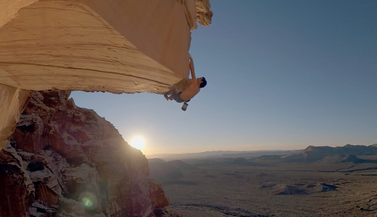 Solo climber Alex Honnold hangs on a rock.