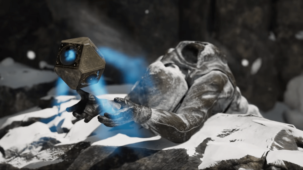 In the rocky ice desert, a glowing stone floats from the hand of a frostbitten man.