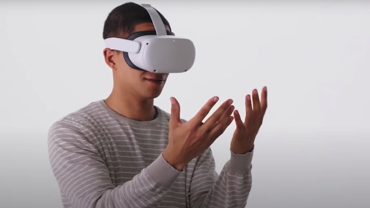 Man looks at his hands tracked with Oculus Quest 2.