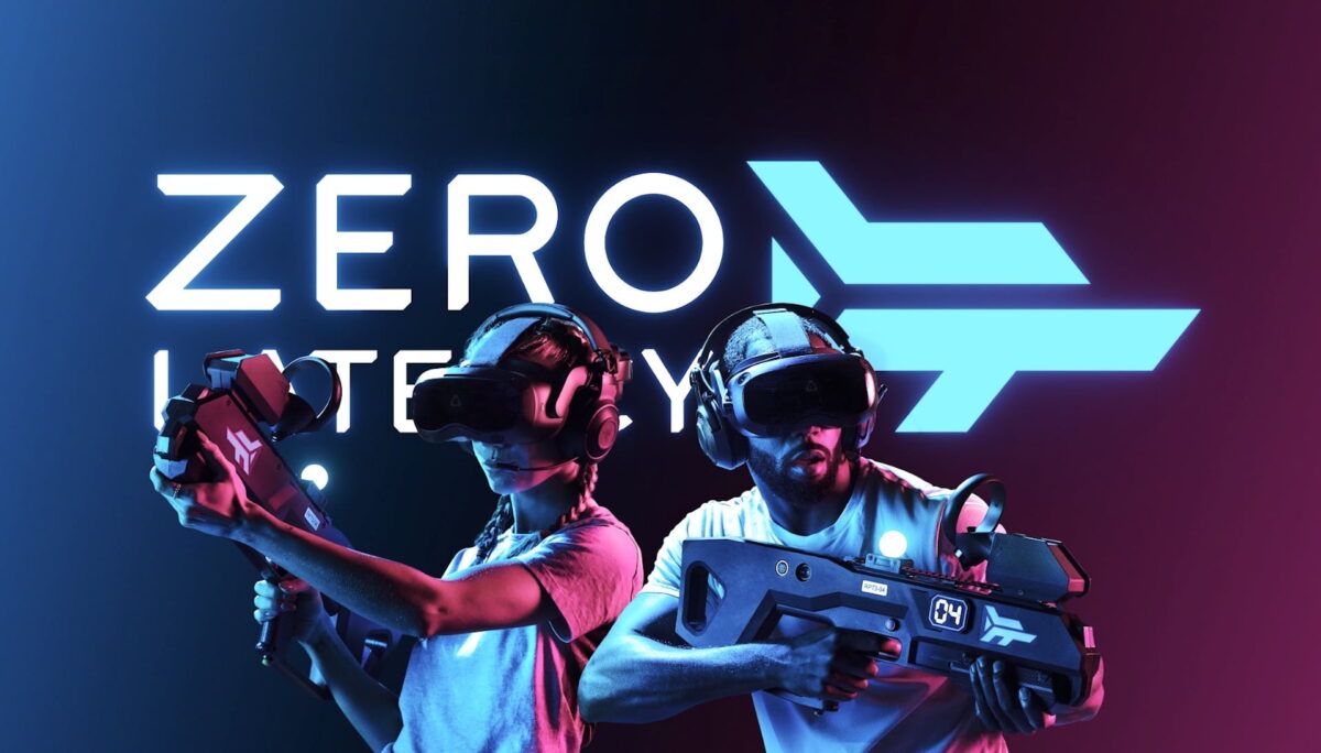 Two arcade visitors with Vive Focus 3 and plastic gun in front of Zero Latency logo.