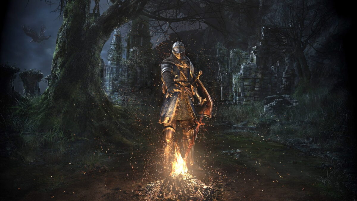 A knight stands over a bonfire, castle ruins in the background.