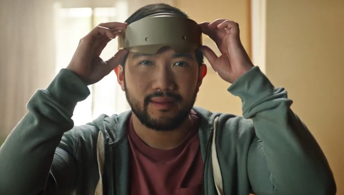 A man puts on a pair of slim VR headset.