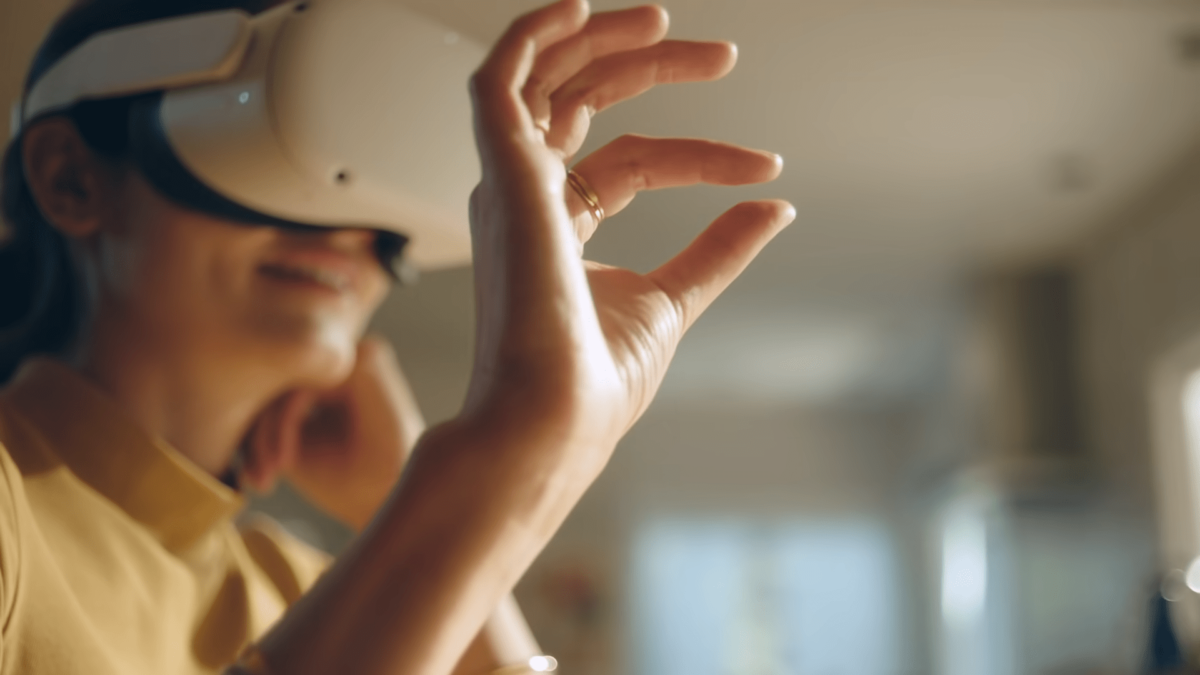 A woman wears VR headset and operates it by hand tracking