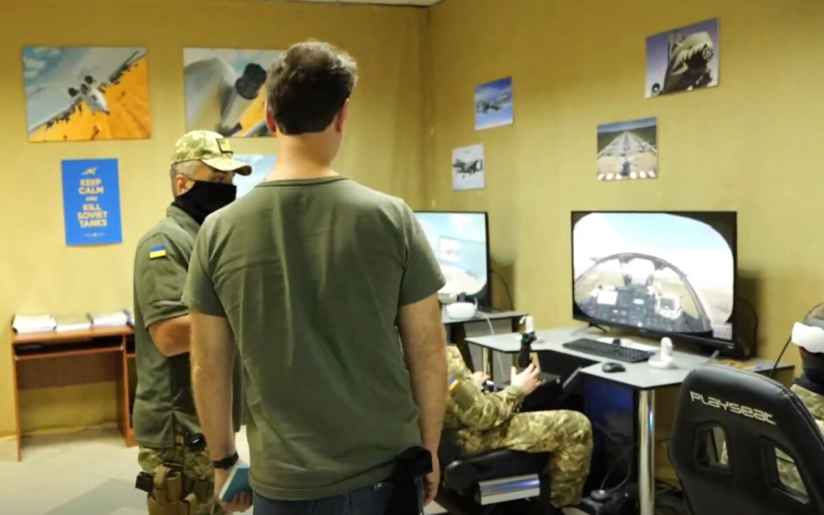 A room with improvised flight simulators, pilots and soldiers.