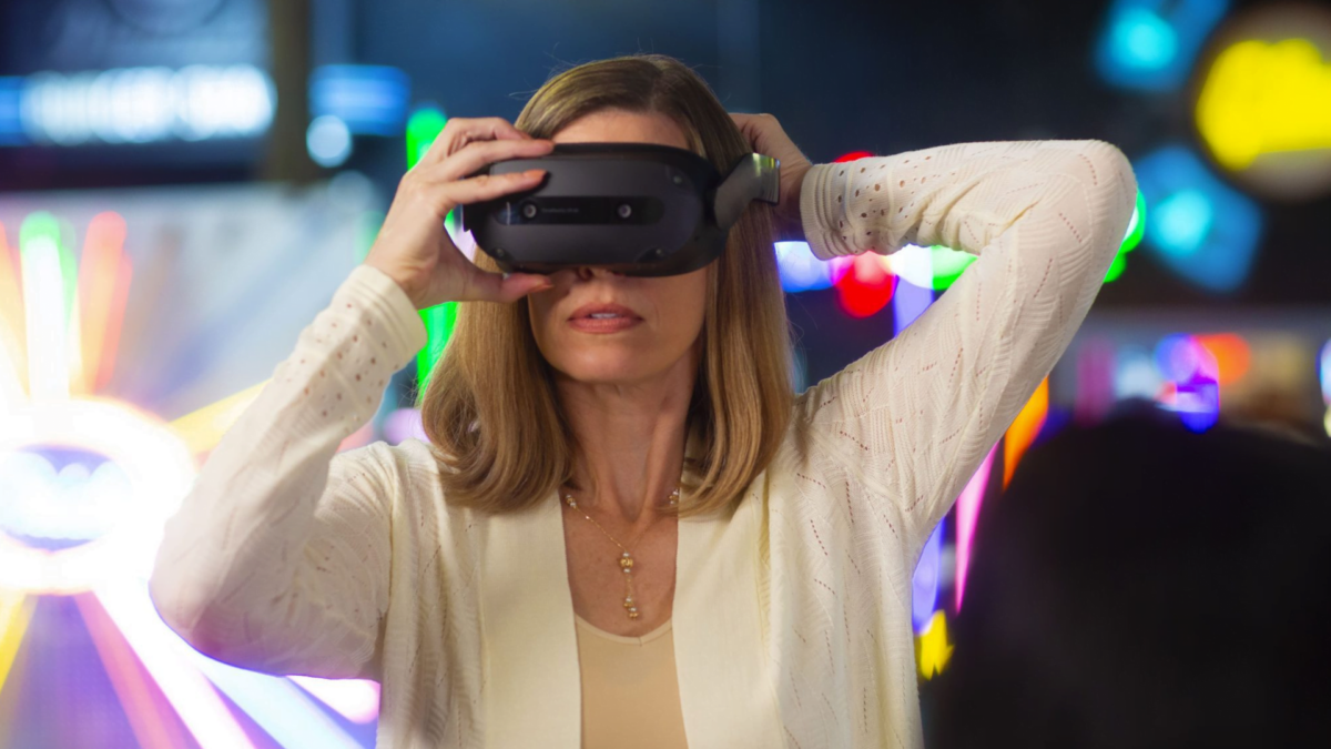 A woman adjusts the Lenovo ThinkReality VR headset.