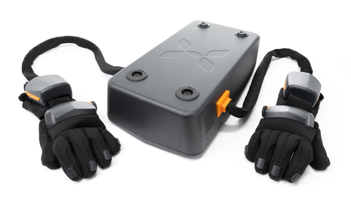 The HaptX Airpack is a dark box with two tubes sticking out of it, with the haptic gloves attached to the end.