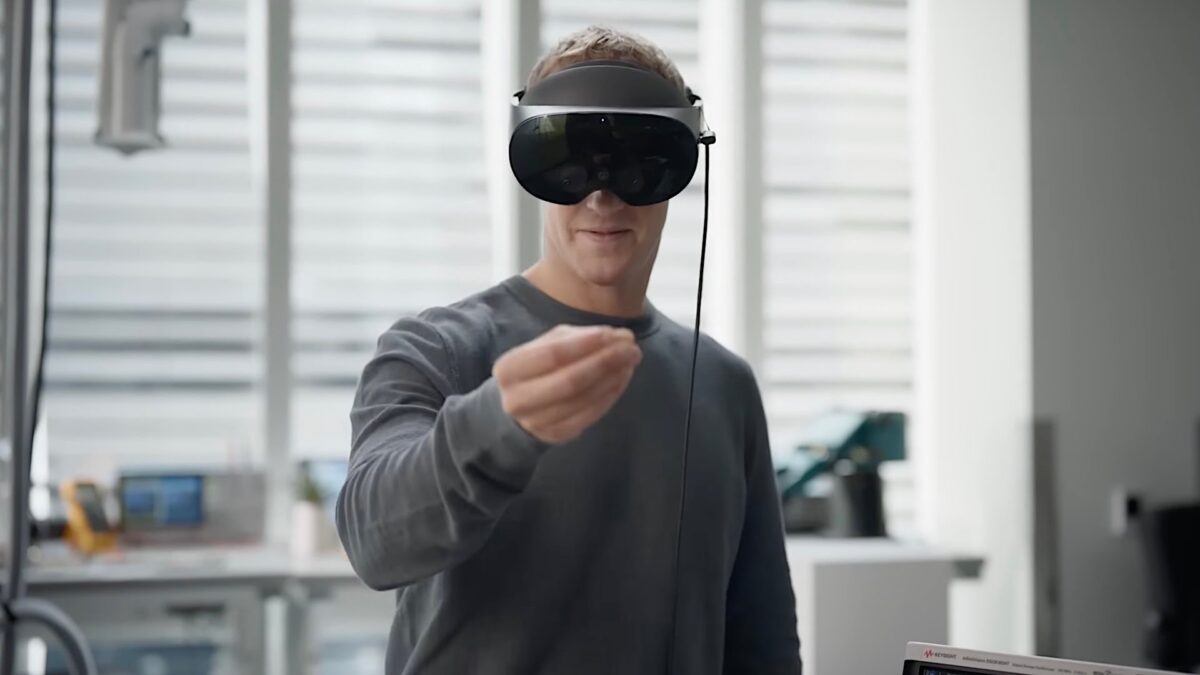 Mark Zuckerberg wears a Meta Quest Pro and reaches out for a virtual object.