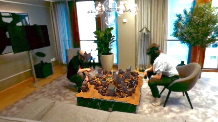 Zwei Demeo-Spieler plays a local multiplayer version of Demeo.  Das Spielbrett ist auf einen Tisch projiziert.