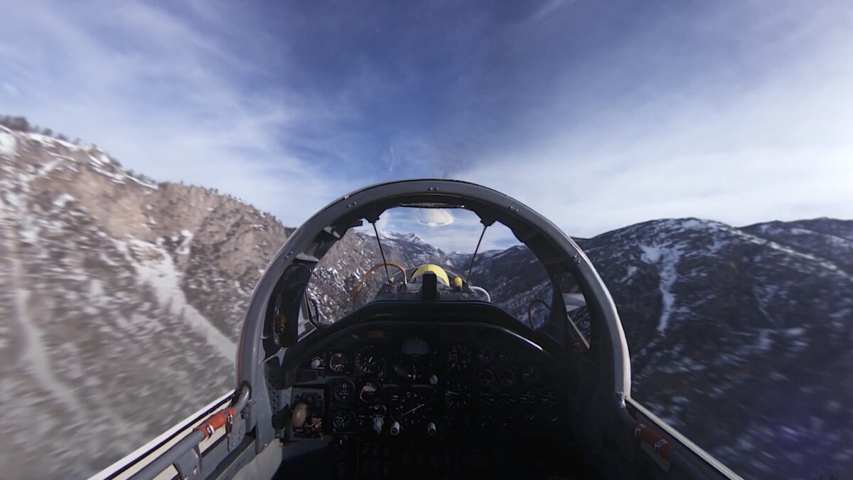 In the copilot's seat of a hypersonic jet, with mountain scenery all around.