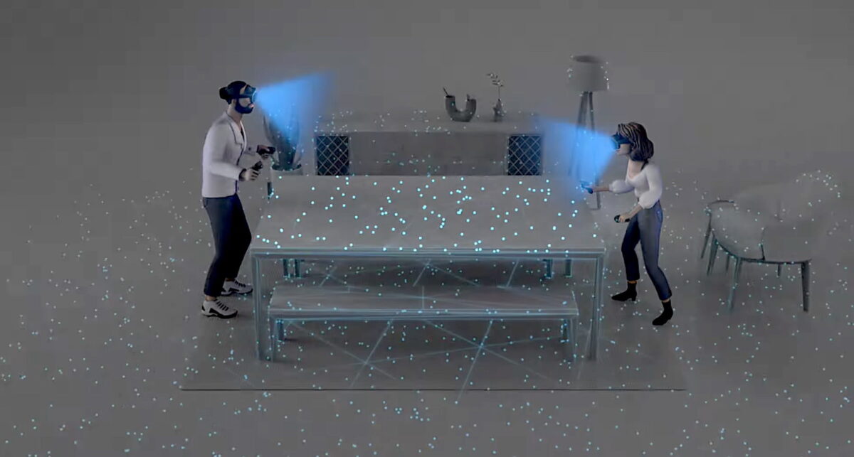 A woman and a man play virtual table tennis on a real table.