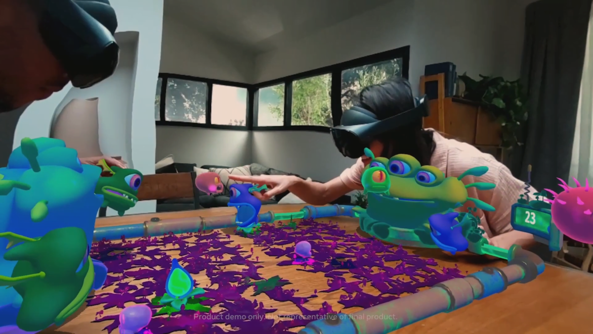 Two players with Quest Pro headset see virtual colorful aliens on the real table in the AR game Slimeball!