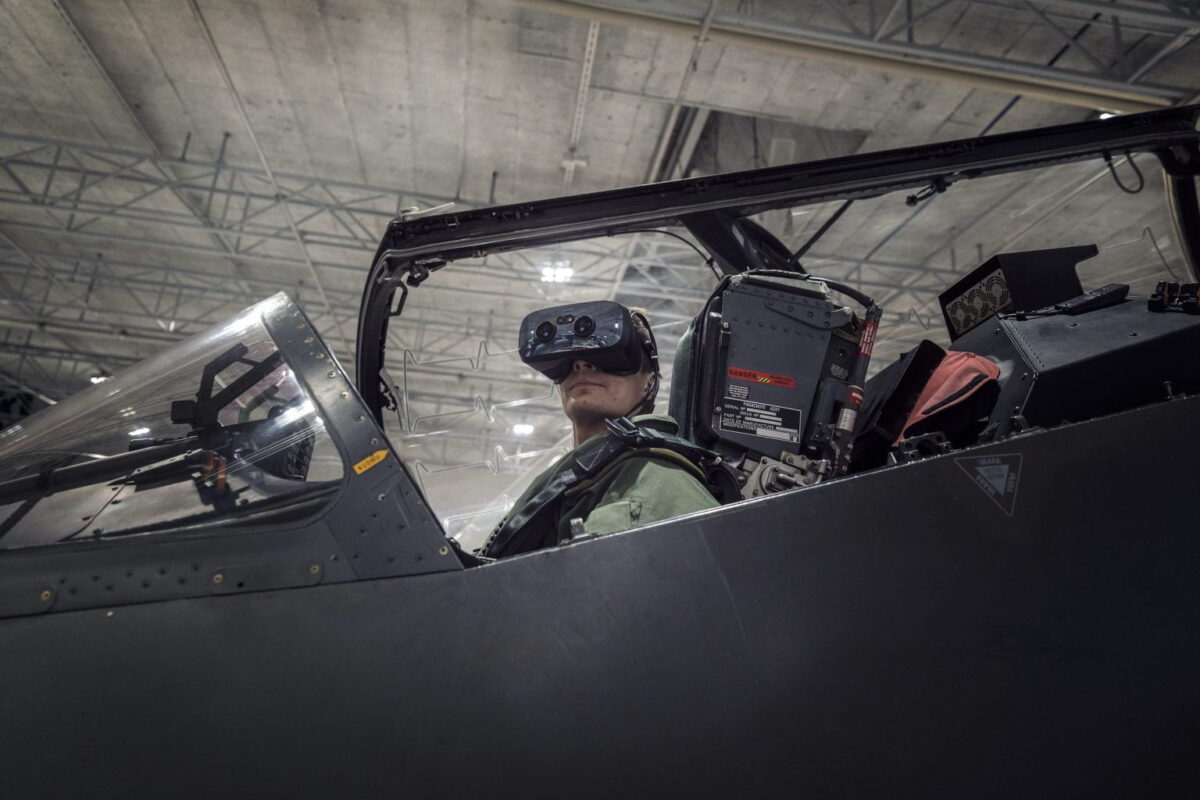 A pilot in the aircraft simulator cockpit looks toward the camera with Varjo XR-3 Focal Edition VR headset.