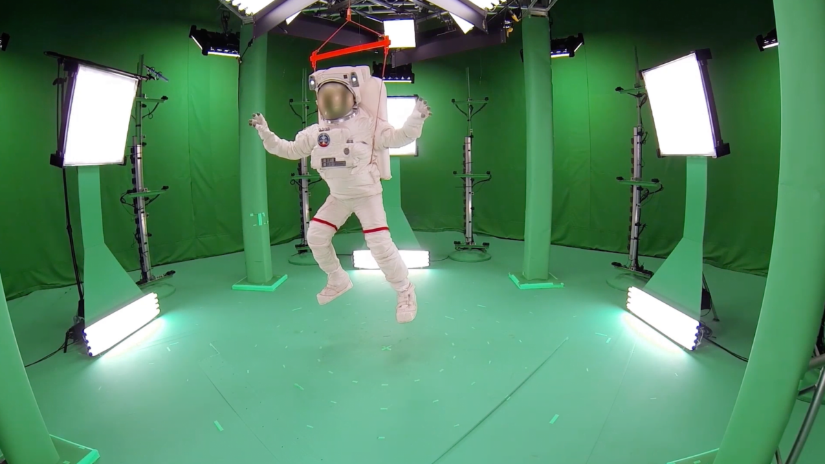 A man in an astronaut suit suspended from scaffolding at one of Microsoft's Capture Studios.