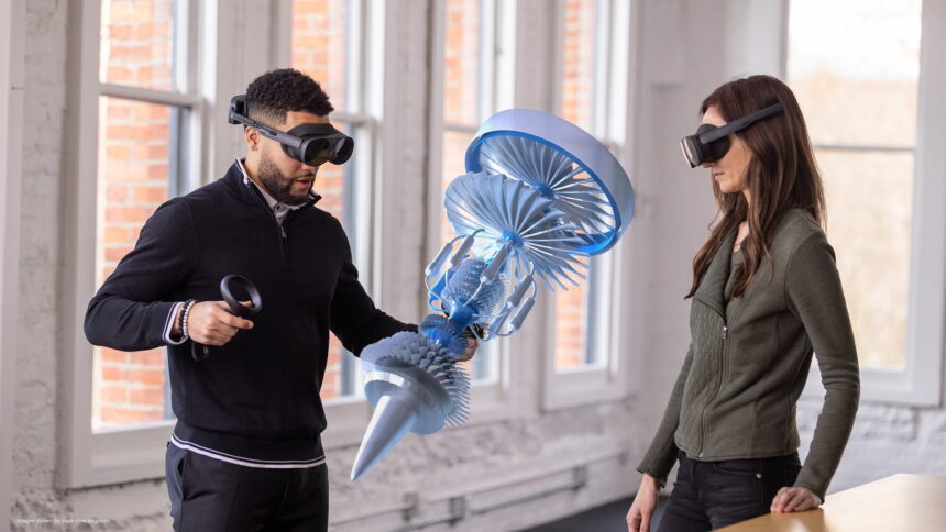 Two users of the Vive XR Elite look at a virtual 3D technical model together in the same room.