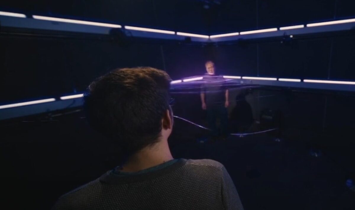 A person is standing in a dark room, sound waves of another person, a young man and an old man, are hitting him. The image is intended to demonstrate how sound waves propagate and transform in space.
