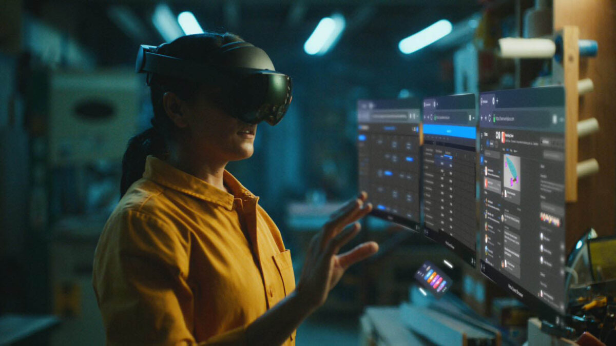 A person wears a Meta Quest Pro and works in a mixed reality view.