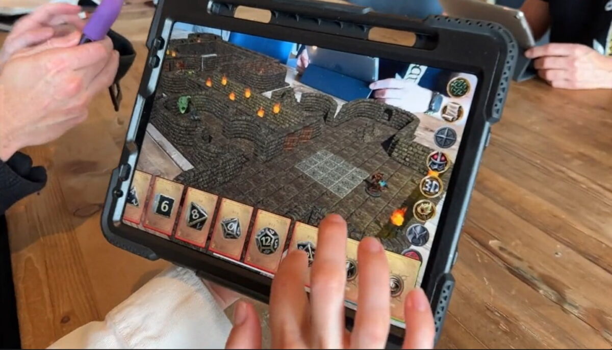 The playing field of a tabletop game is shown on a tablet.