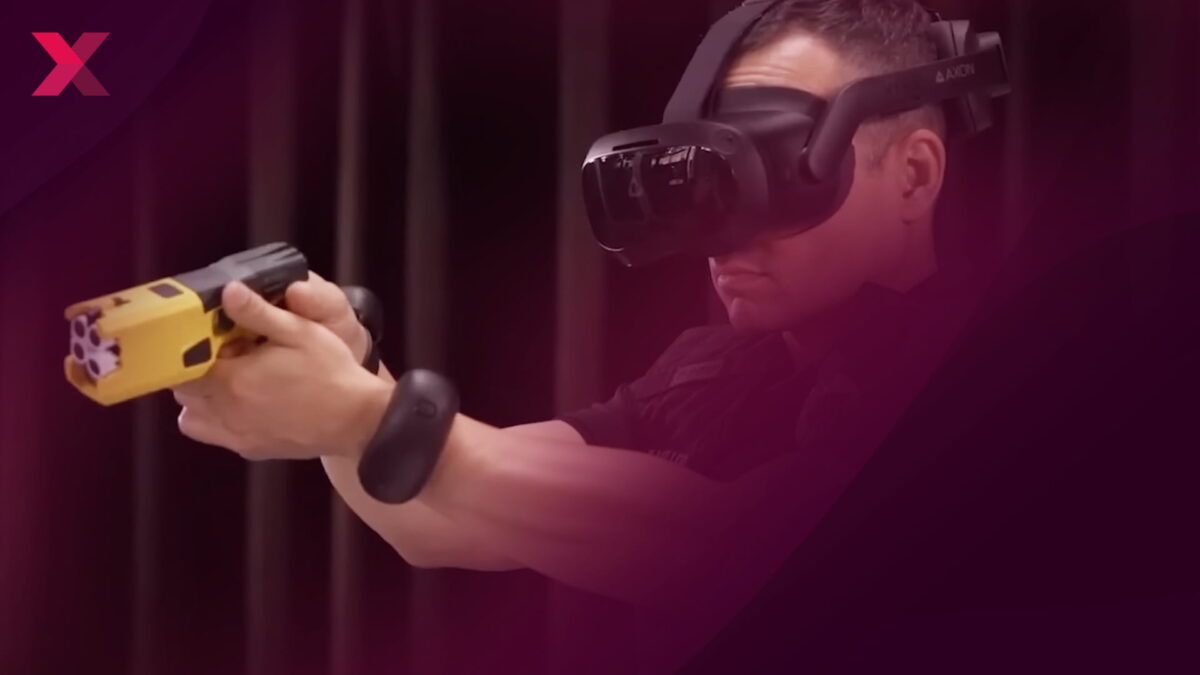 A police officer with Vive tracker on his arm and VR headset aims a practice gun
