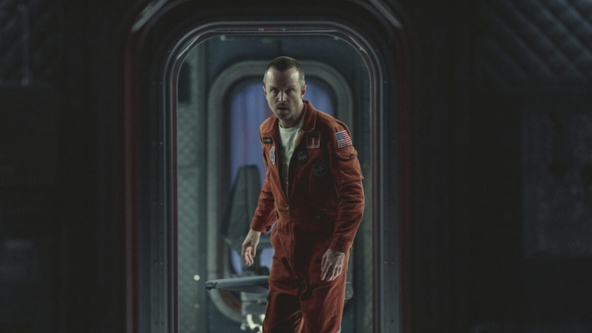 Actor Aaron Paul walks through a hatch in a spacesuit in the series Black Mirror.