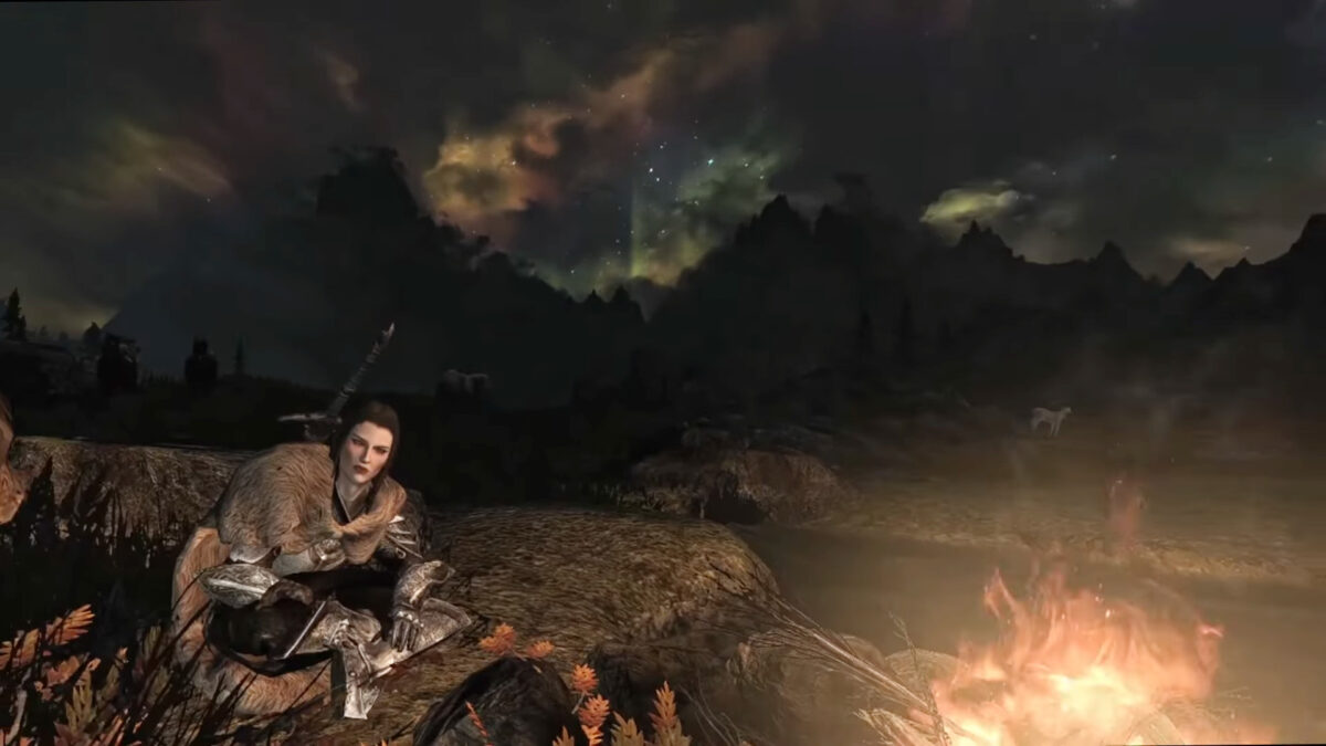 A warrior woman around a campfire in Skyrim VR.