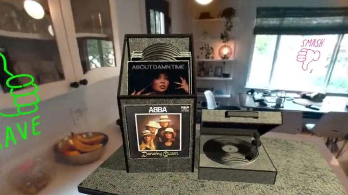 In a mixed reality app for Quest Pro, a virtual record player and a virtual record case stand in a real environment.