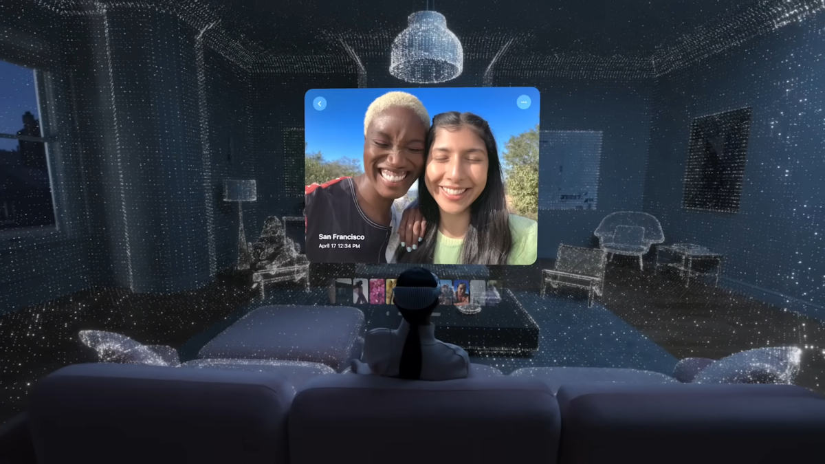 An Apple Vision Pro user on the sofa in front of a virtual selfie.
