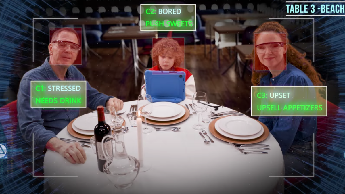 A family sits in a restaurant and is read by an AI waiter who recognizes emotions and needs.