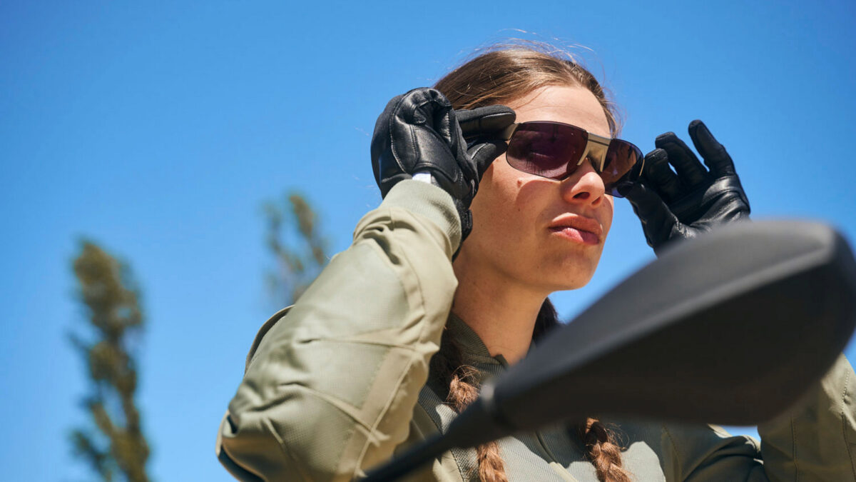 Woman puts on BMW Motorrad ConnectedRide Smartglasses