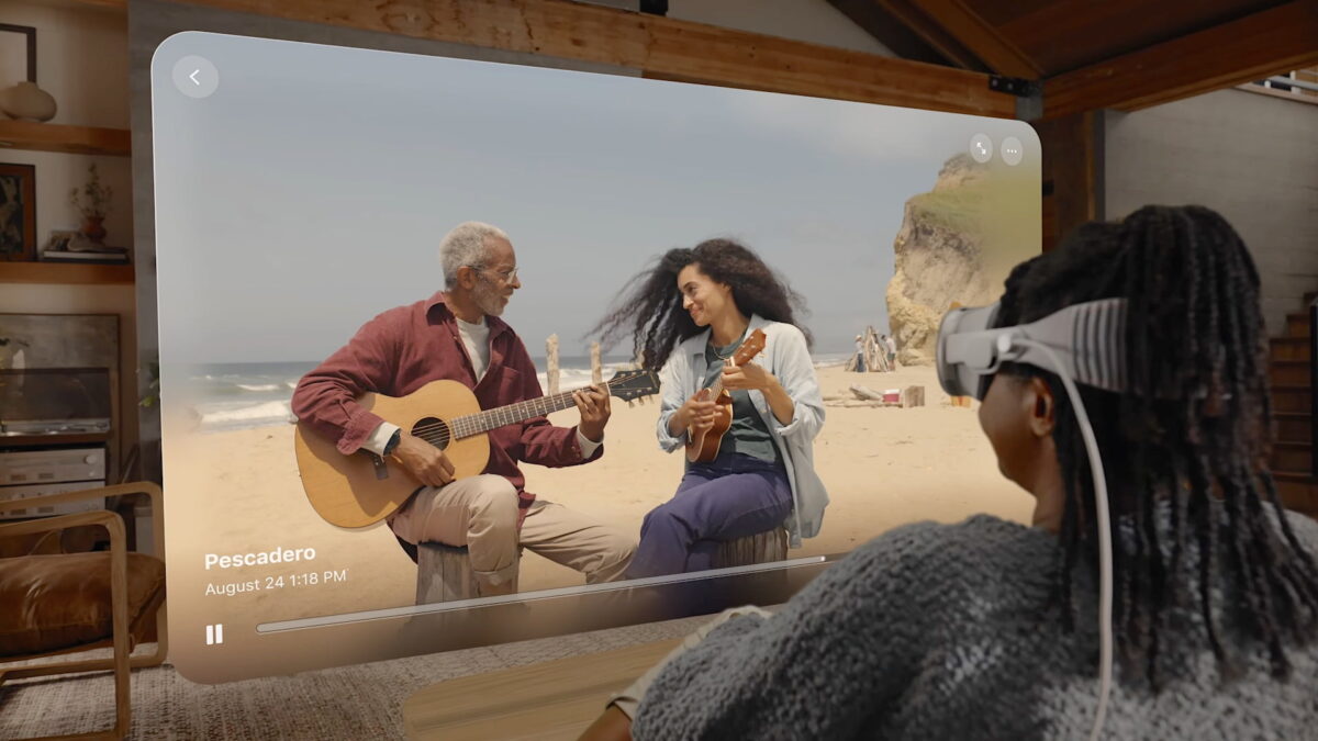 A woman with Apple Vision Pro watches a spatial video she recorded.