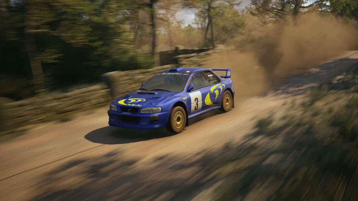 A blue Subaru race car heats up down the track in the WRC racing simulation.