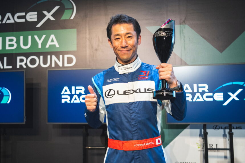 Pilot Yoshi Muroya with the trophy as the winner of Air Race X