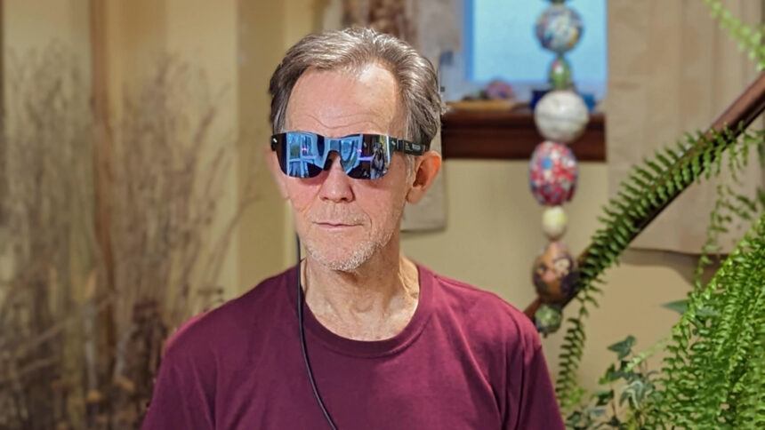 Alan Truly wears RayNeo Air 2 smart glasses while connected to a Sumsung phone.