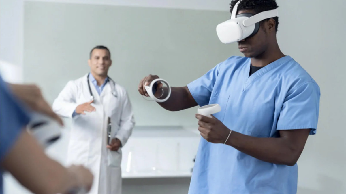A nurse trains with Quest VR headset under the supervision of a doctor standing in the background.