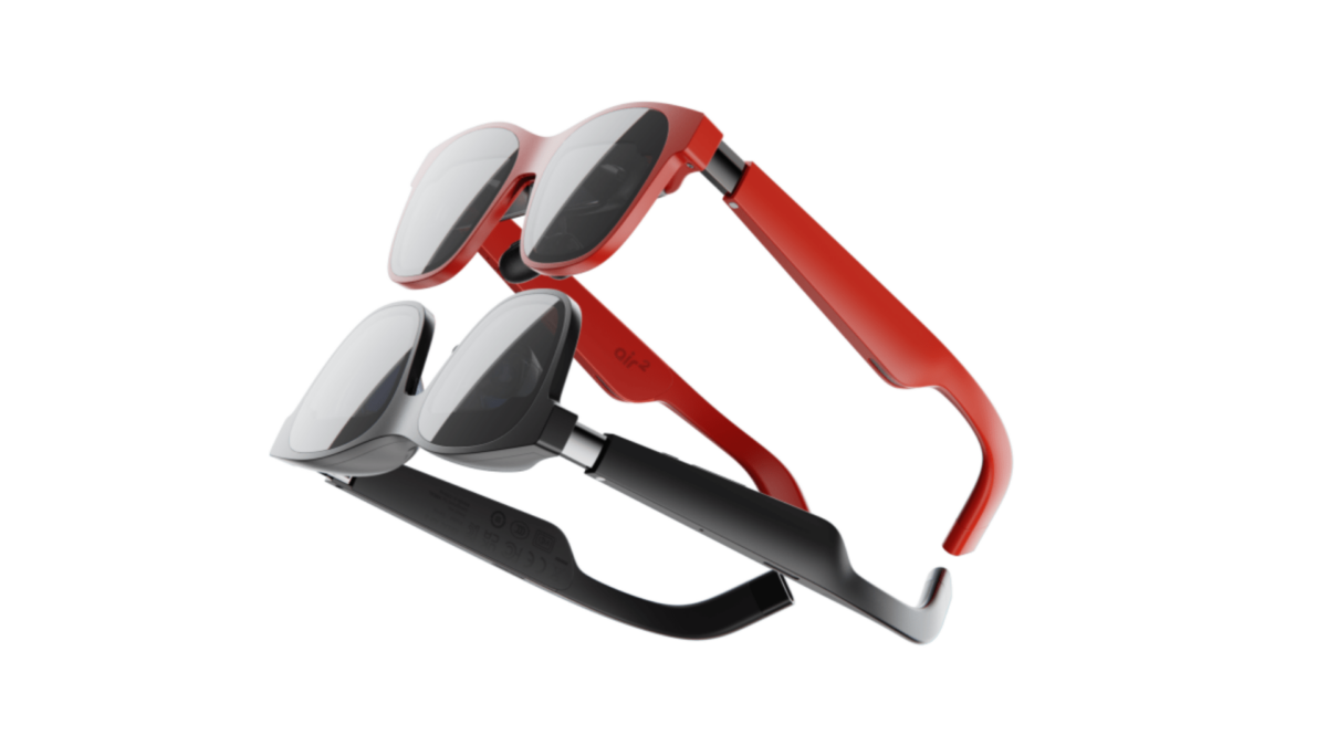 Two Xreal Air 2 AR headsets in the colors red and black lie on top of each other on a white background.