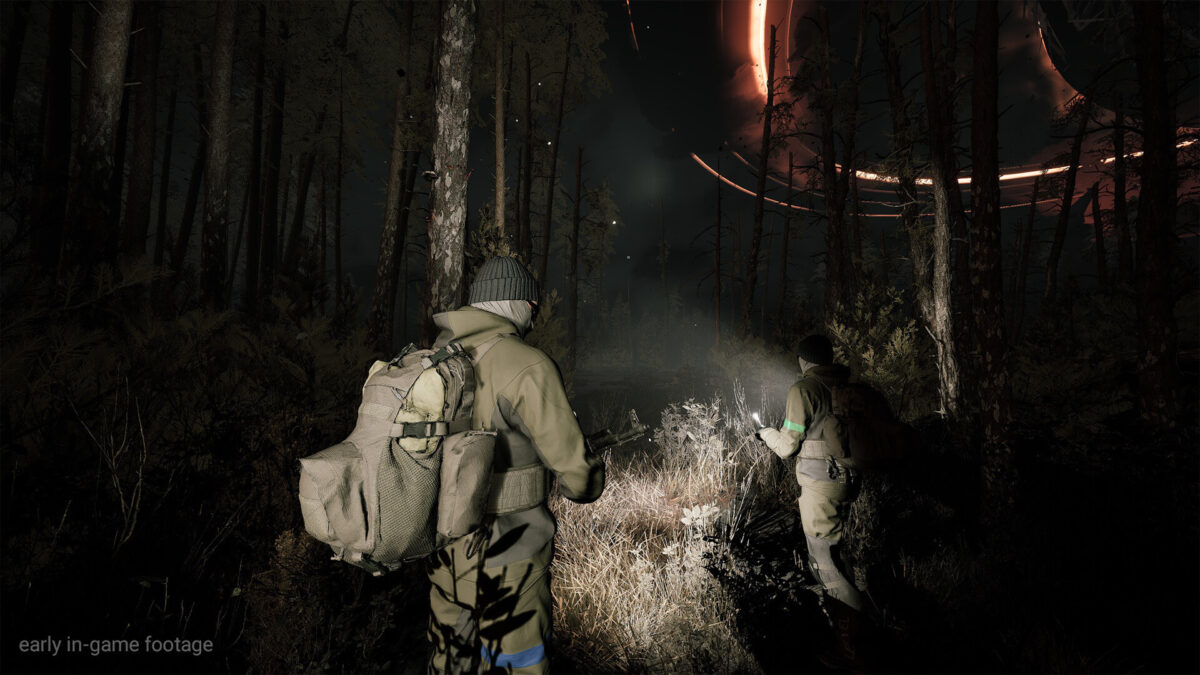 Two players explore a wooded area with flashlights.