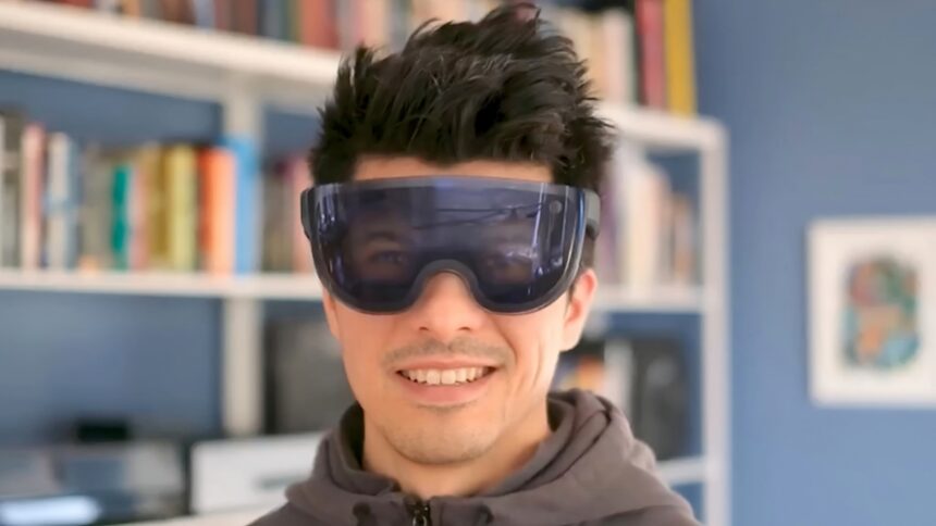 Man with futuristic VR headset that uses reverse passthrough to show the user's eyes.