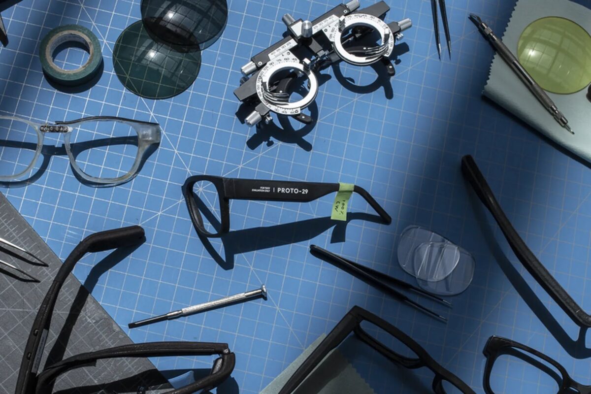 A prototype workbench with various eyewear components.