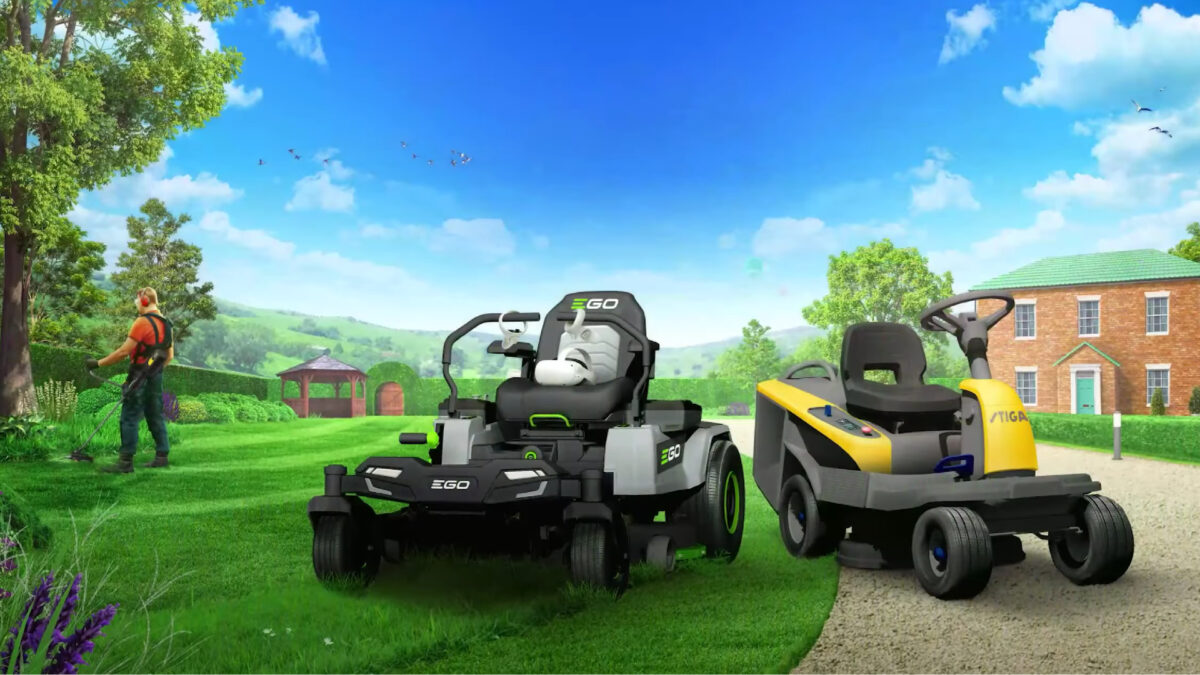 Two mobile lawn mowers and a man with a lawn trimmer are standing on a green lawn in front of a large house.