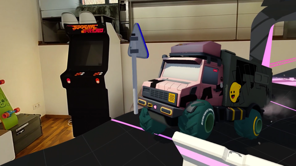 A virtual truck drives on a mixed reality racetrack in a living room.