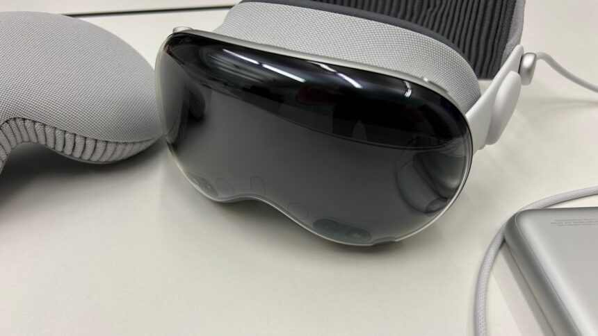VR/AR headset Apple Vision Pro lies on a table between the protective cover and the battery