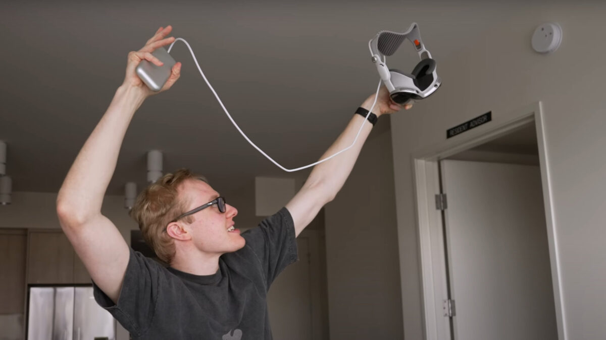 AppleTrack's Sam Kohl holds the $3,500 Apple Vision Pro over his head for a drop test.
