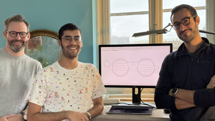 Brilliant Labs Co-Founders stand in front of a computer display with the Frames design.