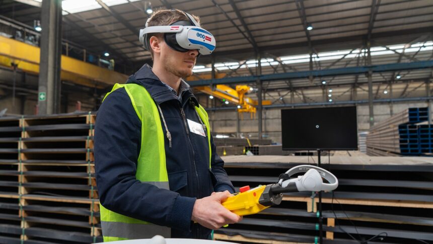 A crane operator with a yellow safety vest, remote crane control and VR headset.