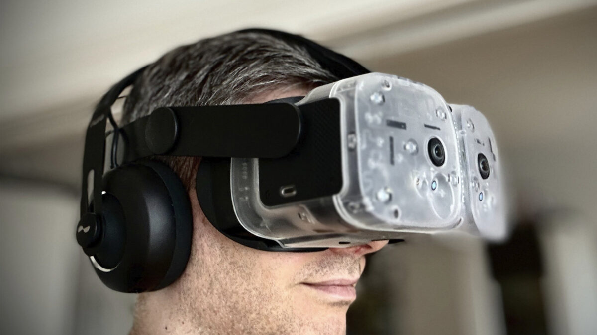 A man wears transparent Somnium VR1 with headphones.
