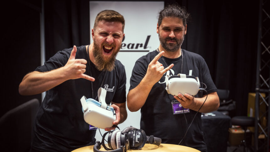 Two men hold a VR headset in their hands and pose for the camera with surfer salutes and devil horns.