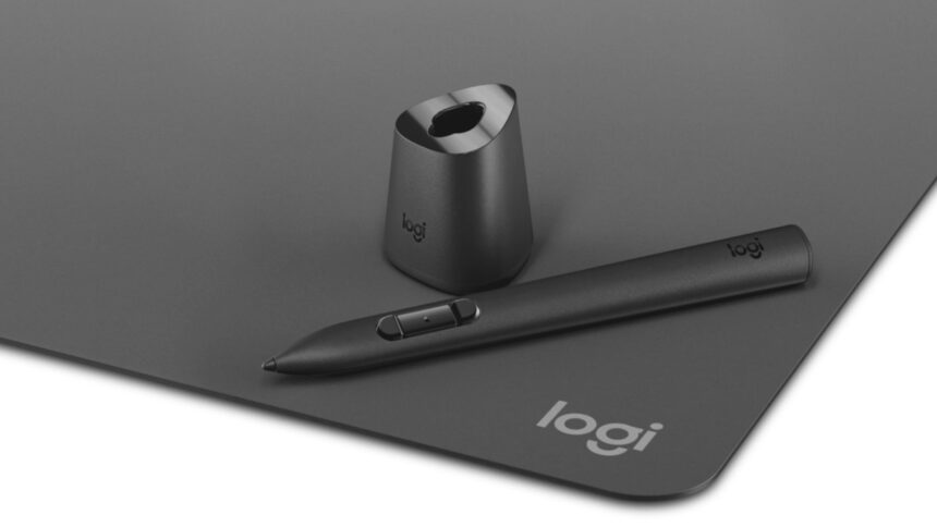 The Logitech MX Ink Mixed Reality pen on a writing surface next to a charging base.